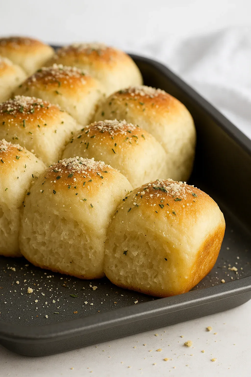 A pan of bread rolls with seasoning.