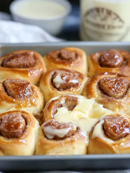 A tray of pastries with white icing.