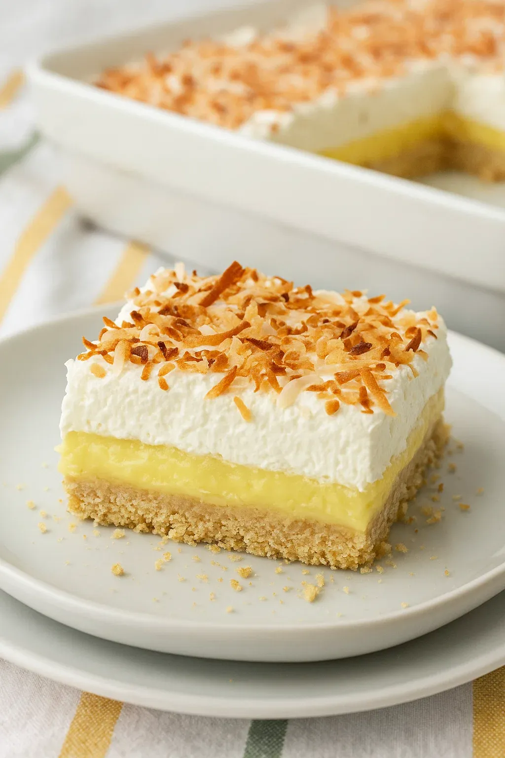 A slice of coconut cake on a plate.