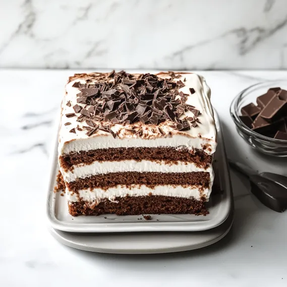 A slice of cake with chocolate and white frosting.