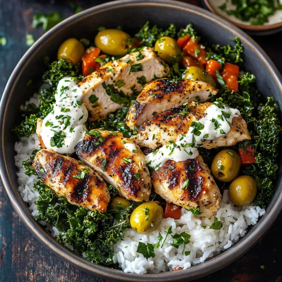 A bowl of food with rice, chicken, and vegetables.