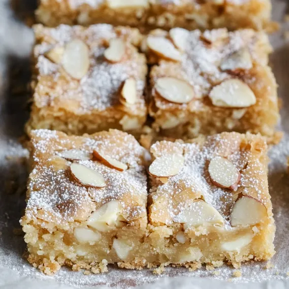 A square of almond cake with powdered sugar.