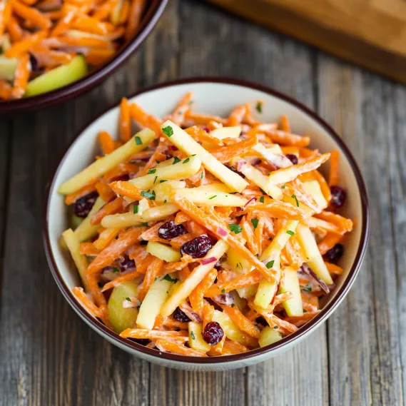 A bowl of carrots and apples.