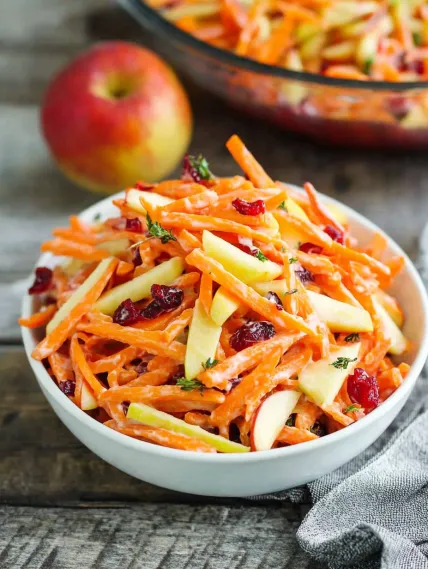 A bowl of carrots and apples.