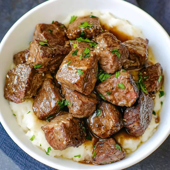 A bowl of meat and potatoes.