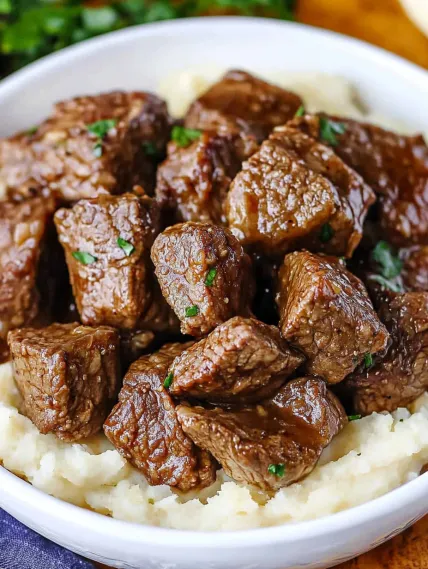 A bowl of meat and potatoes.