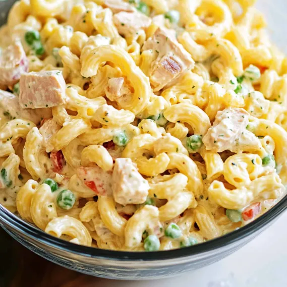A bowl of pasta with meat and peas.