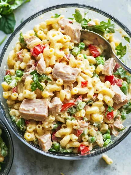 A bowl of pasta with meat and vegetables.