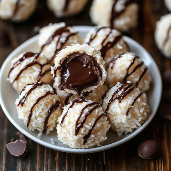 A plate of chocolate covered coconut balls.