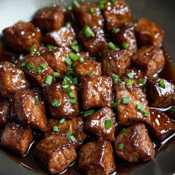 A plate of meat with sauce.