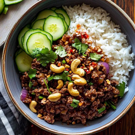 A bowl of food with rice, cucumbers, and peppers.