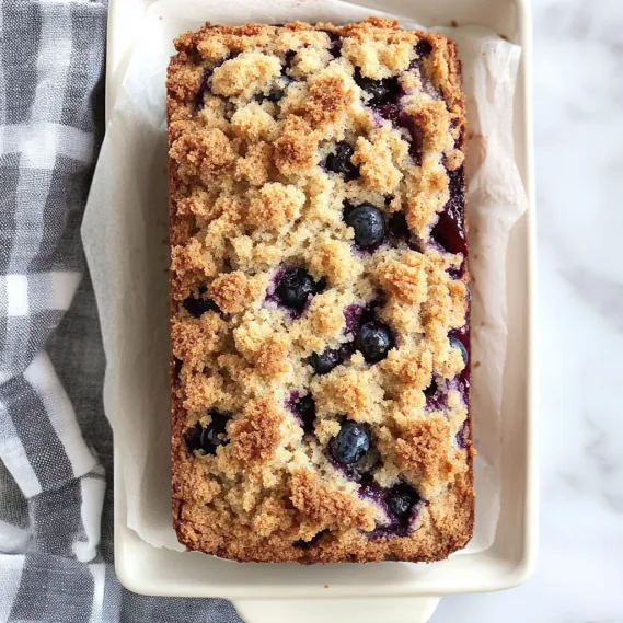 A loaf of bread with blueberries on top.