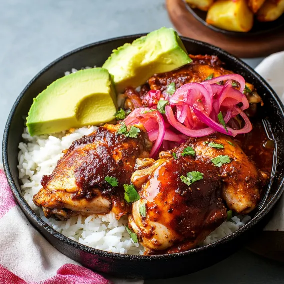 A plate of food with rice, chicken, and avocado.