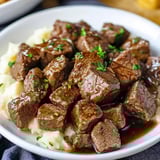 A plate of meat and potatoes.